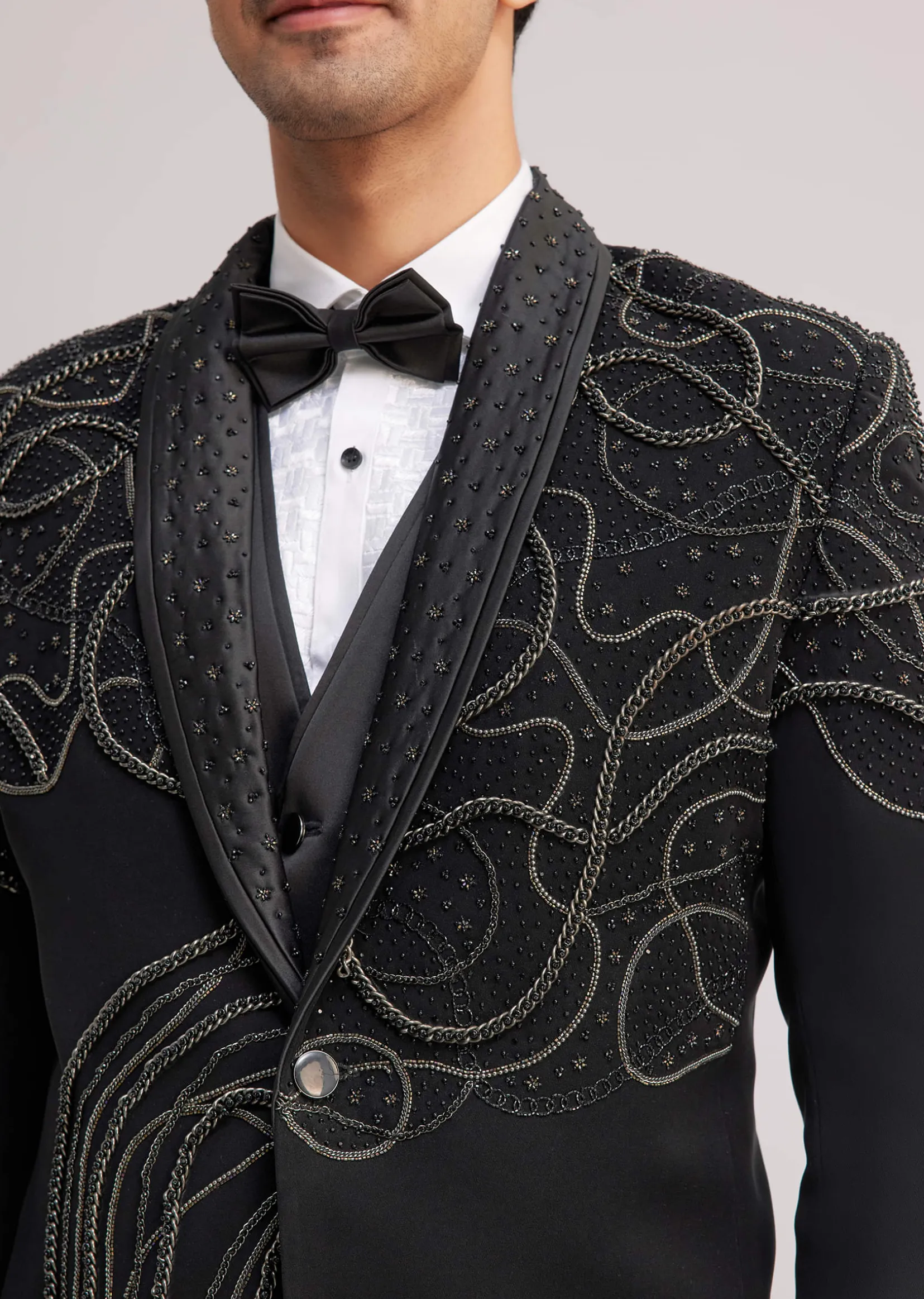 Black Suiting Tuxedo With Metallic Chain And Stone Work