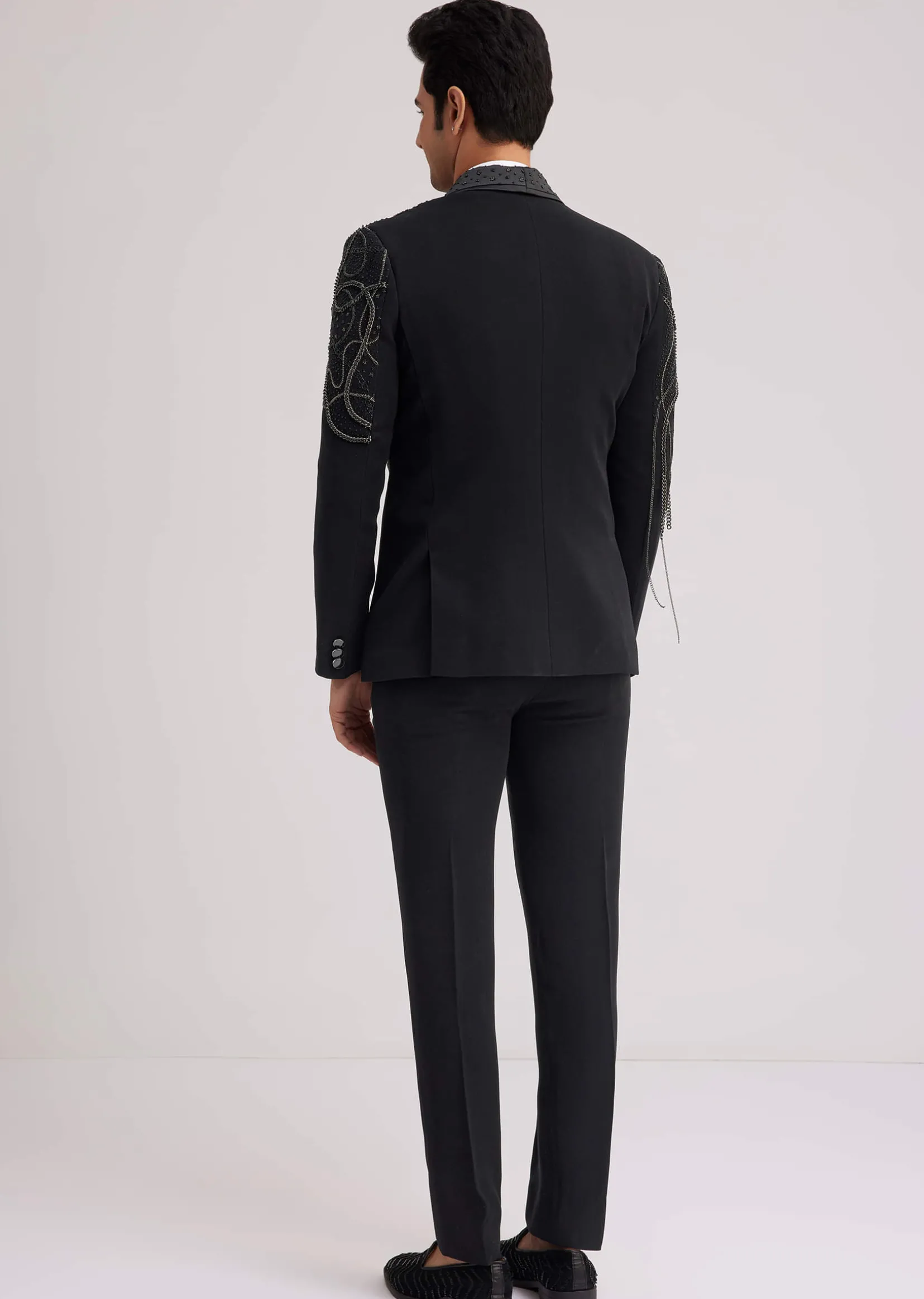 Black Suiting Tuxedo With Metallic Chain And Stone Work
