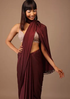 Blood Red Satin Saree With Fringes On The Pallu Paired With Hand Embroidered Bustier