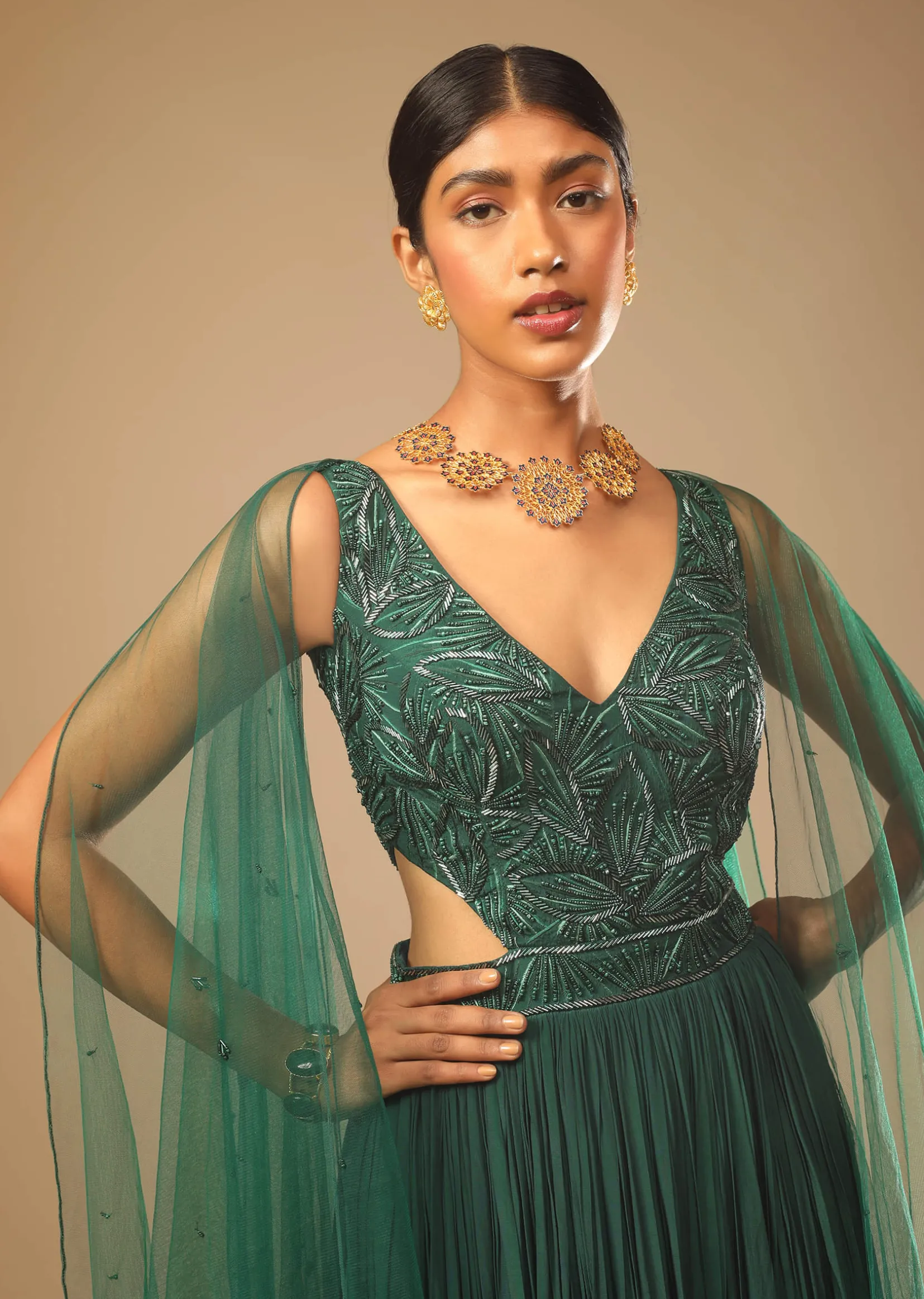 Bottle Green Gown In Crepe With Side Cut Outs In The Hand Embroidered Bodice