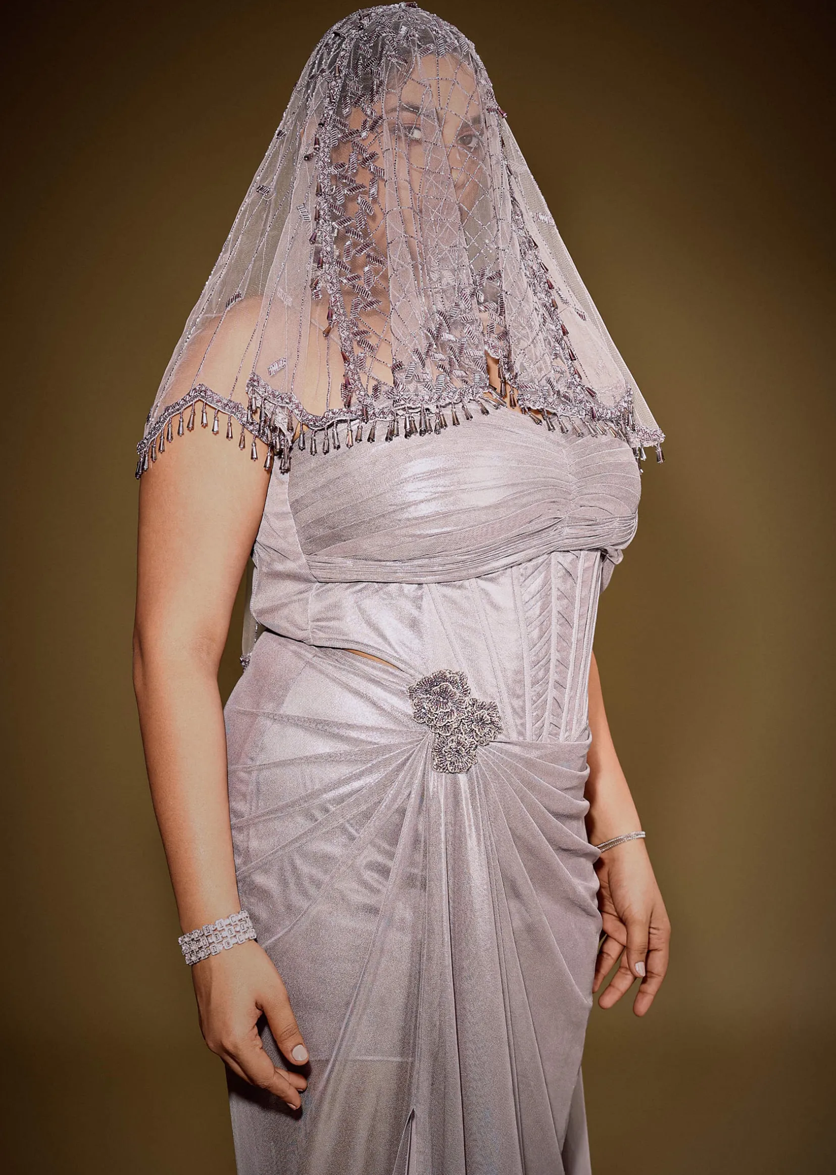 Gold One Shoulder Drape Gown With Embroidered Floral Brooch And Trail