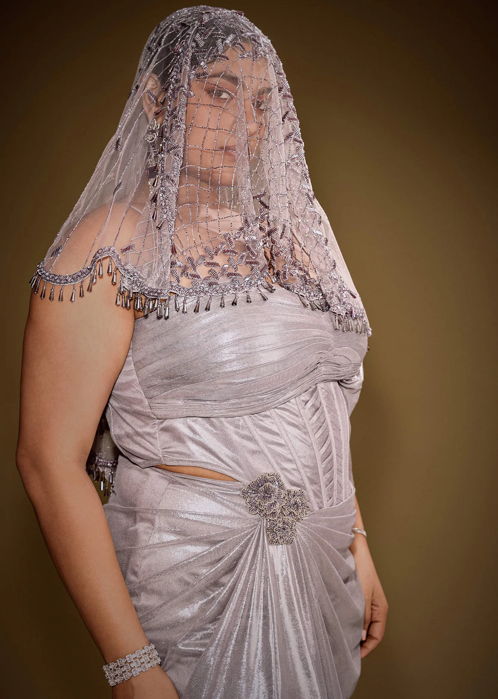 Gold One Shoulder Drape Gown With Embroidered Floral Brooch And Trail