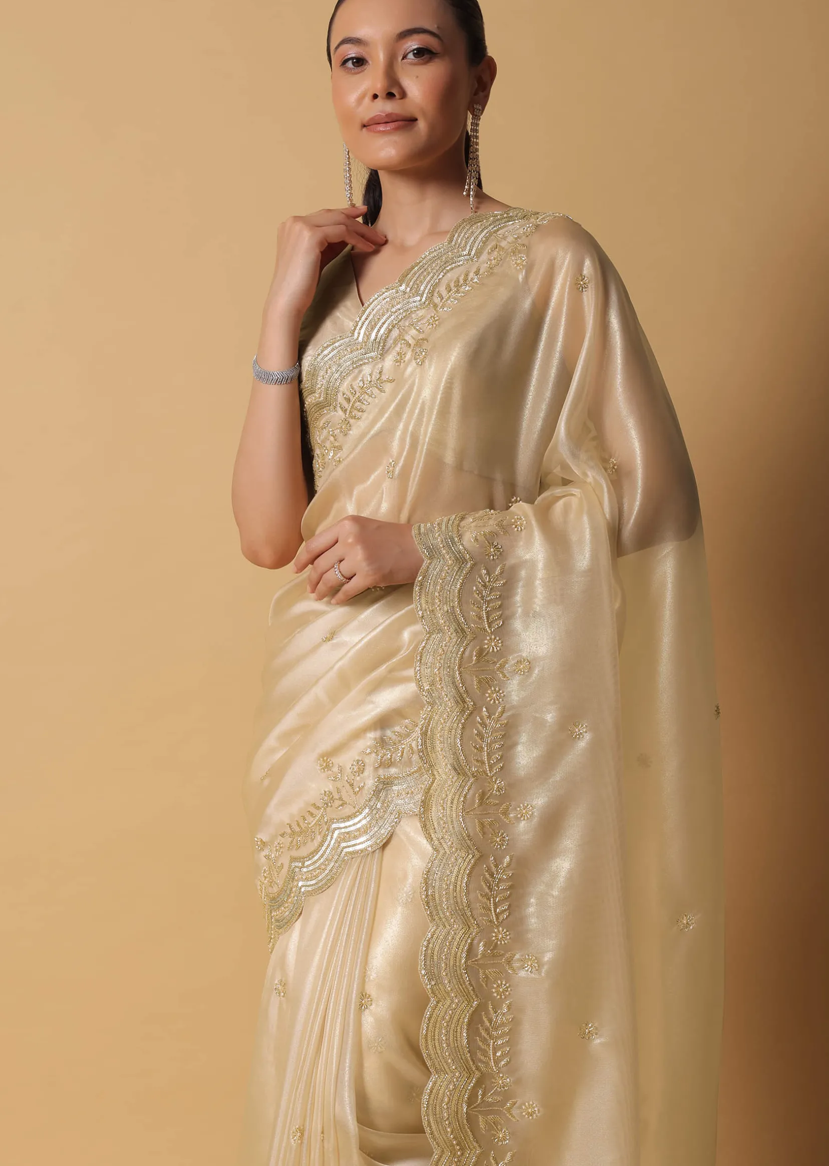 Gold Toned Foil Saree Fabricated In Tissue With Cut Dana Embellished Borders