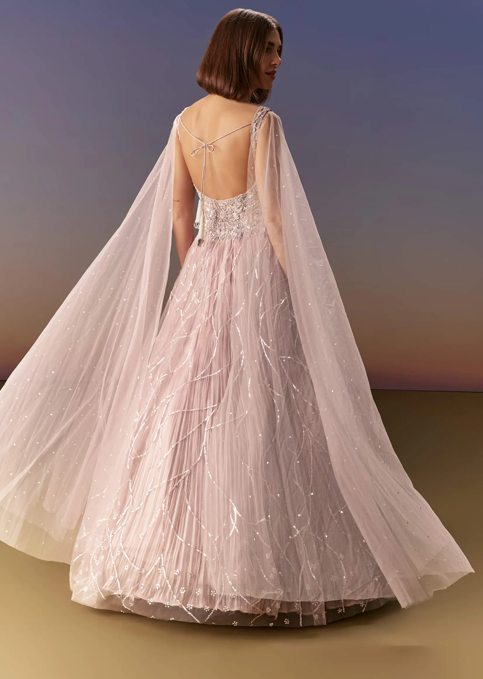 Pastel Pink Gown With Sheer Cape Drape And Heavy Embroidery
