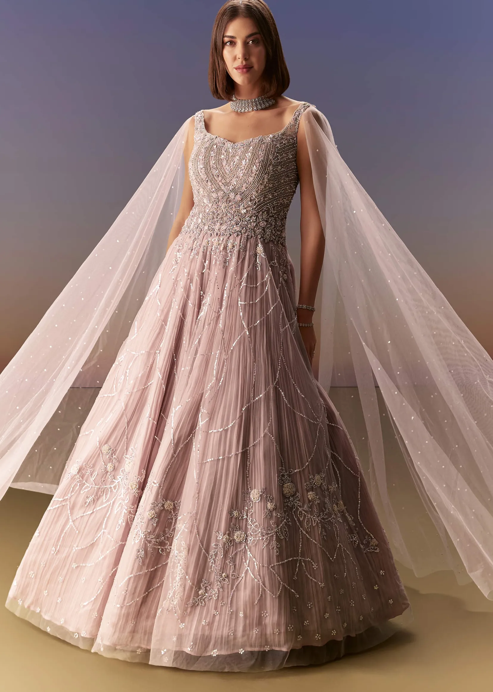 Pastel Pink Gown With Sheer Cape Drape And Heavy Embroidery