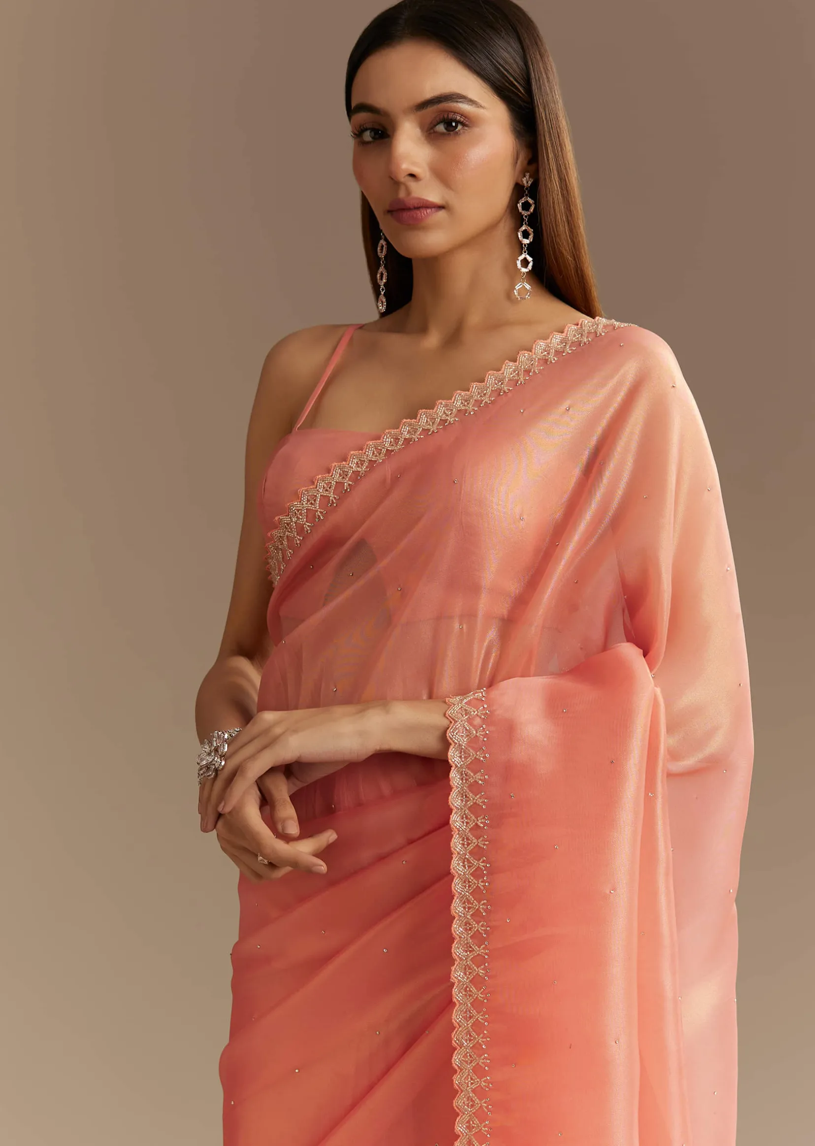 Peach Tissue Saree With Stones Cutdana Embellishments And Scallop Border