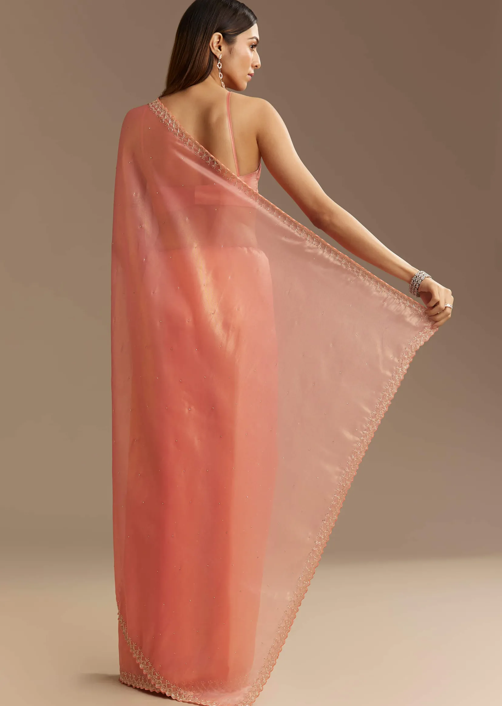 Peach Tissue Saree With Stones Cutdana Embellishments And Scallop Border