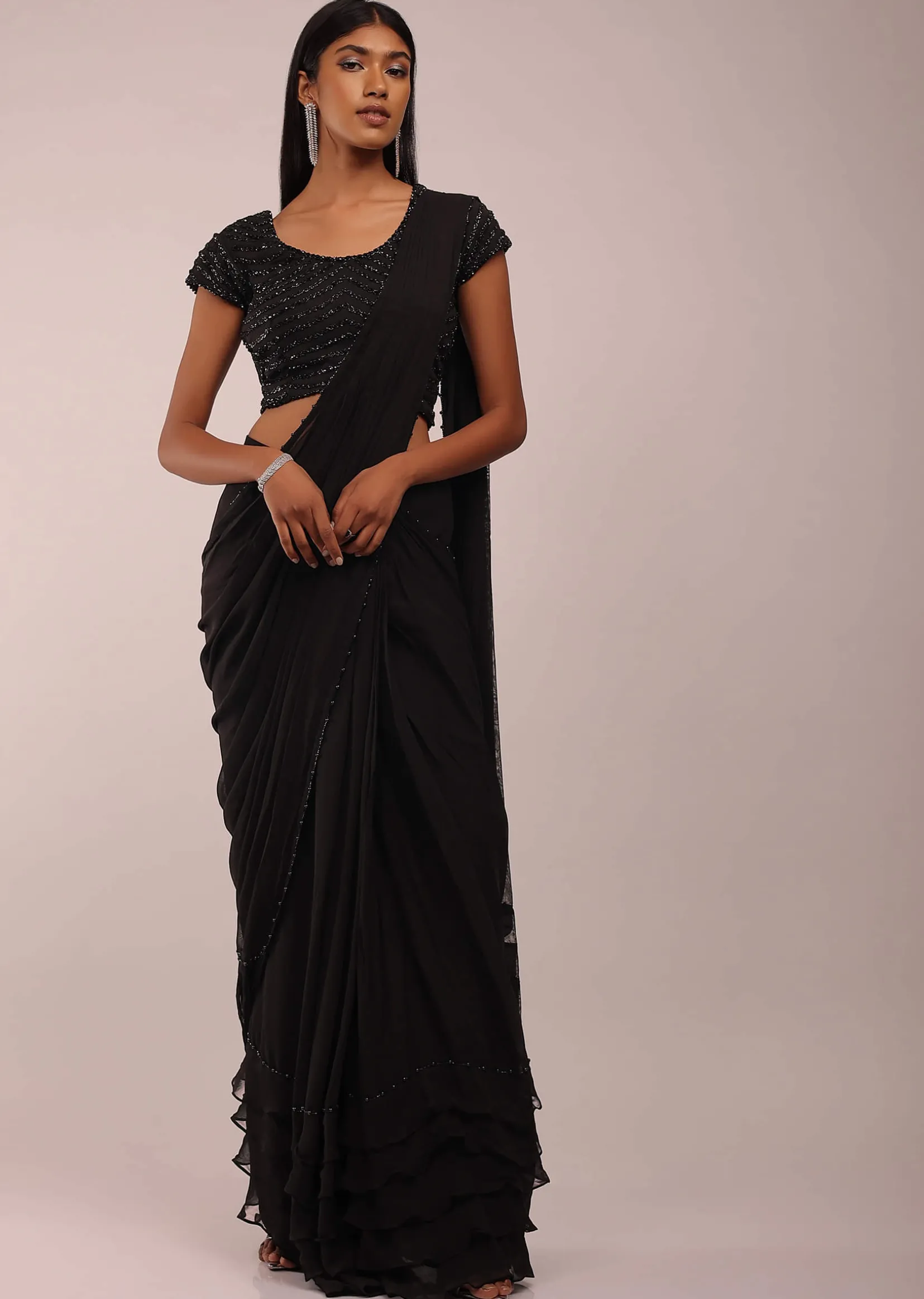 Pitch Black Saree With Three Tones Of Layered Frills On The Bottom Embellished In Stones And Sequins With A Tassel On The Pallu Corner