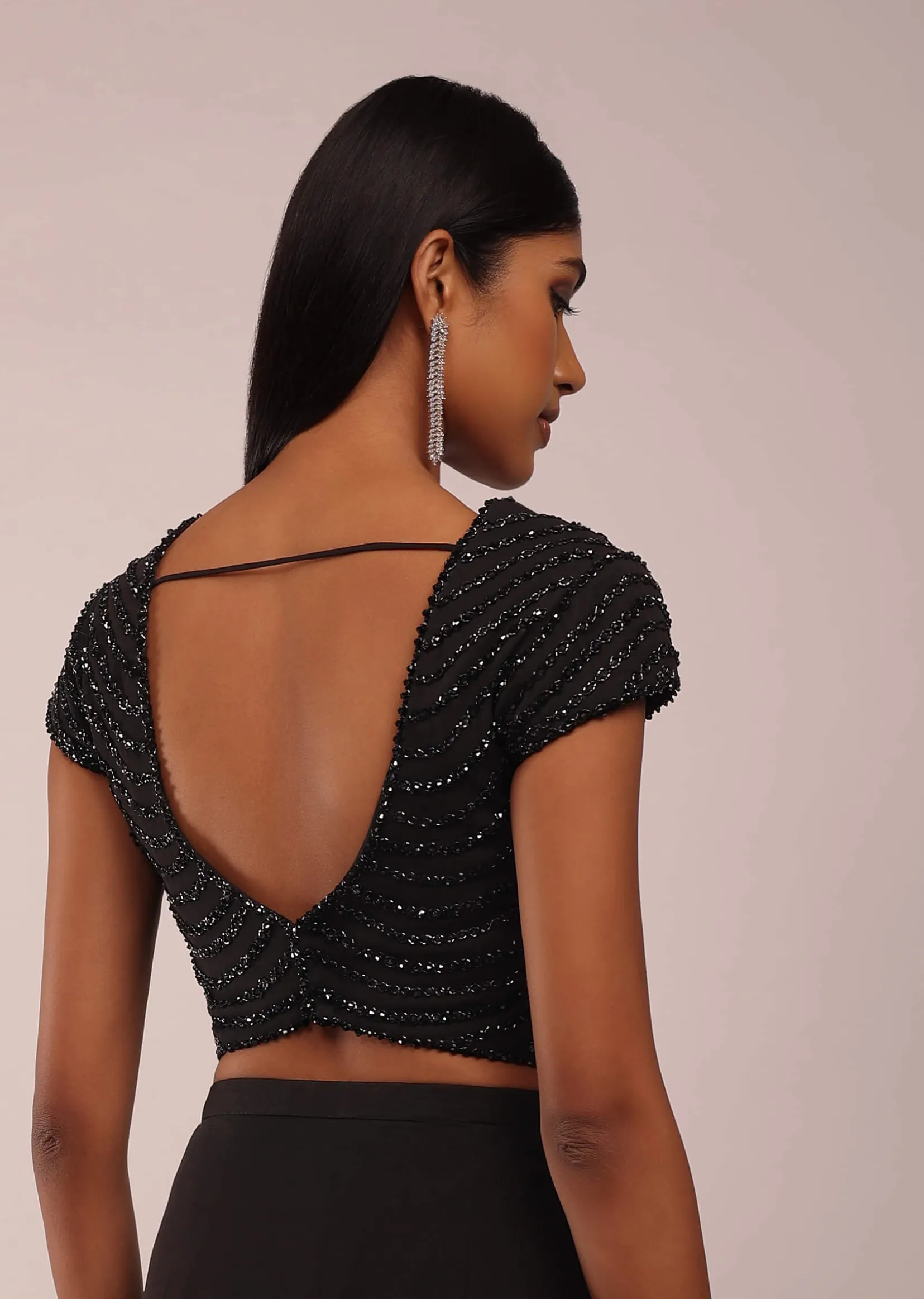 Pitch Black Saree With Three Tones Of Layered Frills On The Bottom Embellished In Stones And Sequins With A Tassel On The Pallu Corner