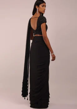 Pitch Black Saree With Three Tones Of Layered Frills On The Bottom Embellished In Stones And Sequins With A Tassel On The Pallu Corner
