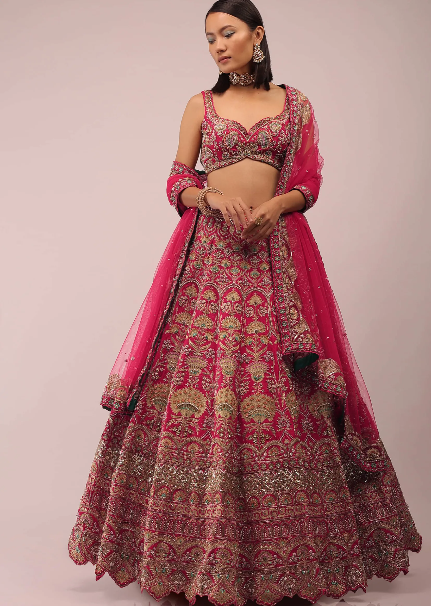Rani Pink Lehenga In Golden Zari Work Embroidery Inspired By Mughal Architecture With Matching Net Dupatta In Embroidered Buttis