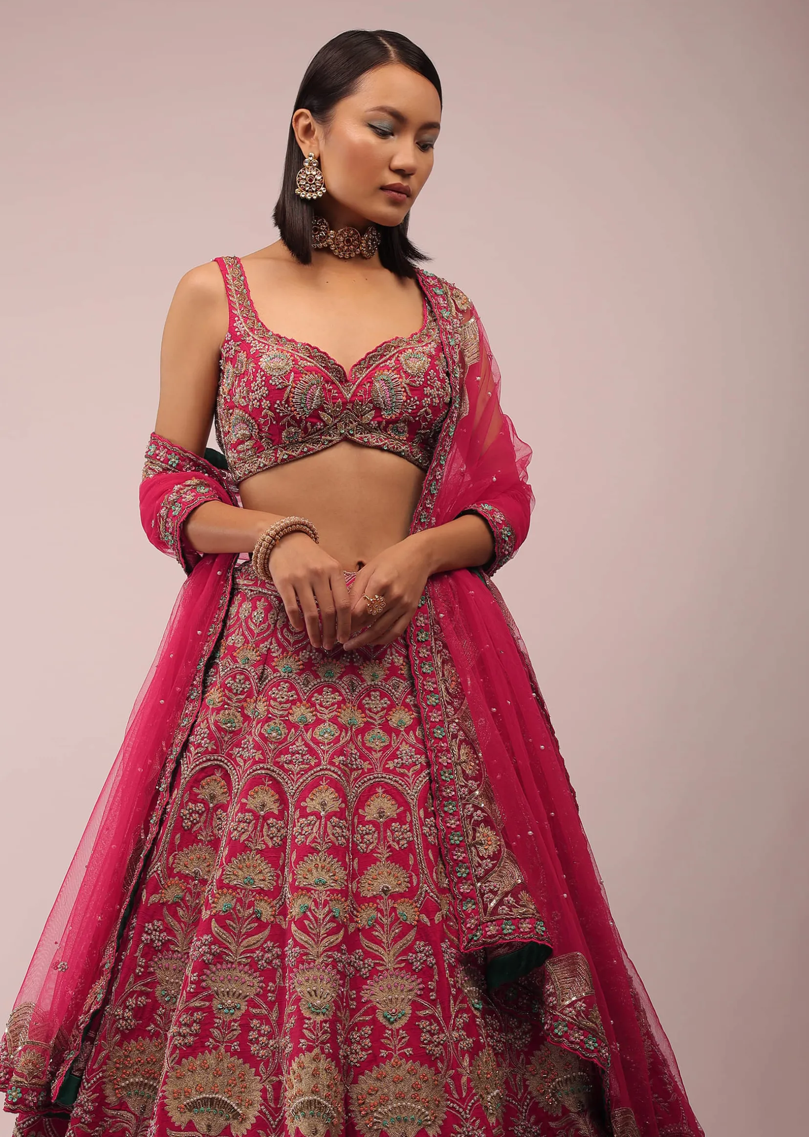 Rani Pink Lehenga In Golden Zari Work Embroidery Inspired By Mughal Architecture With Matching Net Dupatta In Embroidered Buttis