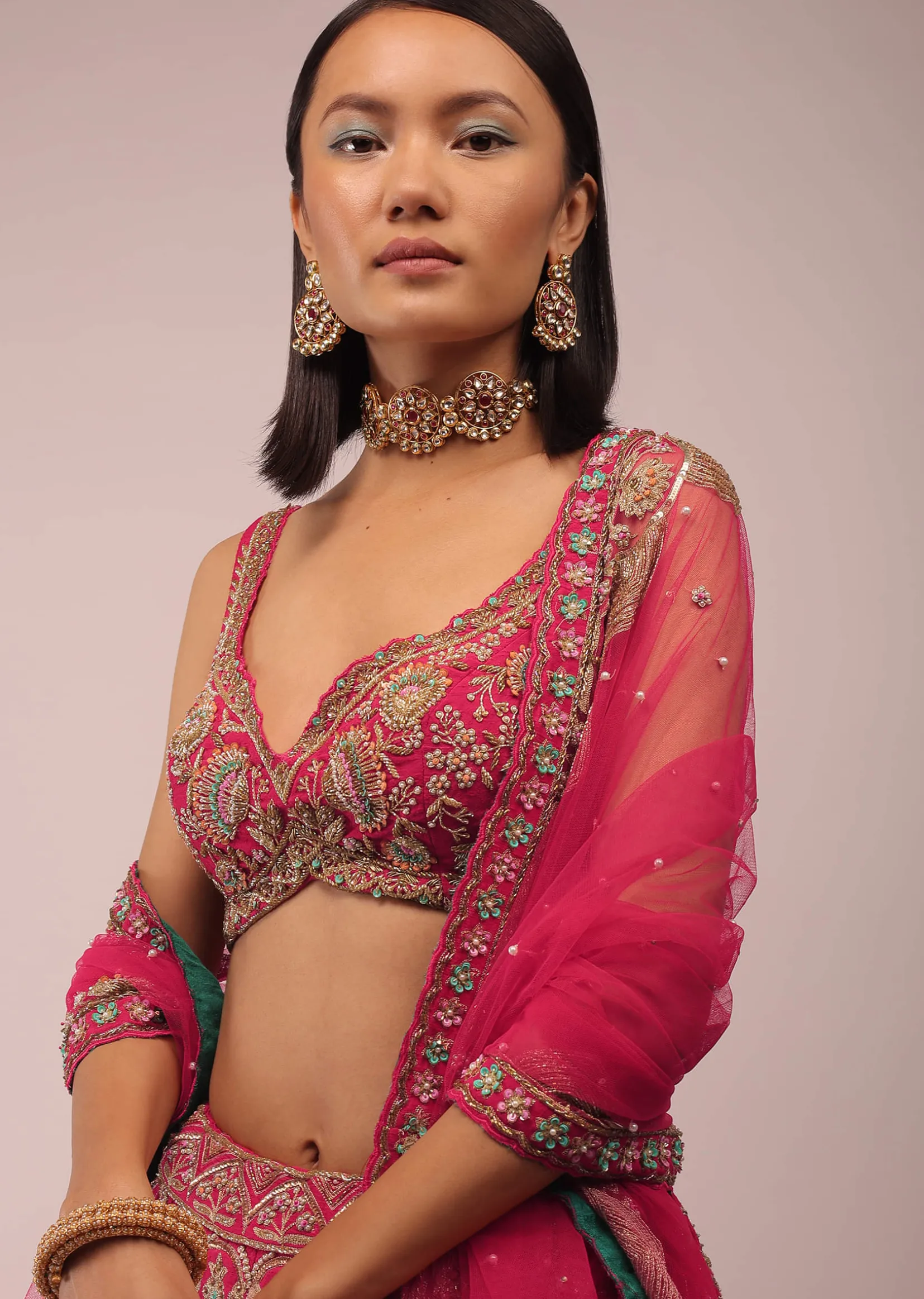 Rani Pink Lehenga In Golden Zari Work Embroidery Inspired By Mughal Architecture With Matching Net Dupatta In Embroidered Buttis