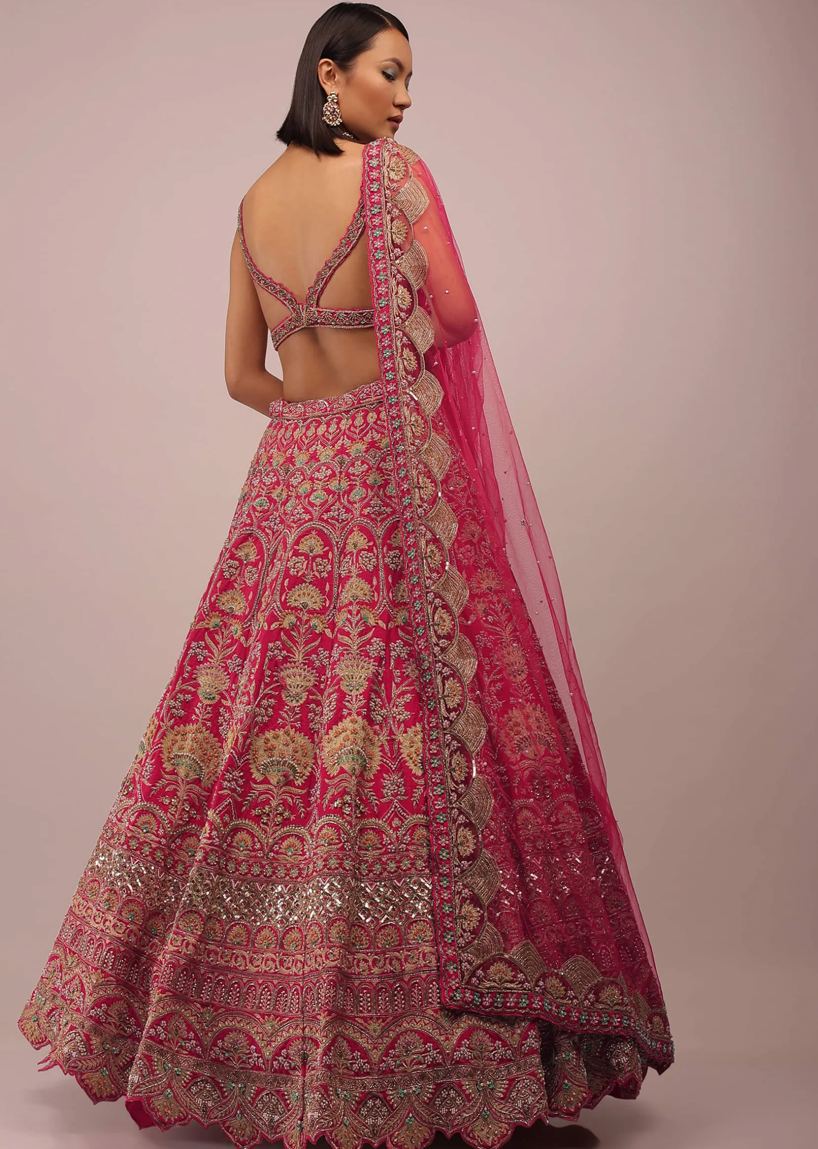 Rani Pink Lehenga In Golden Zari Work Embroidery Inspired By Mughal Architecture With Matching Net Dupatta In Embroidered Buttis