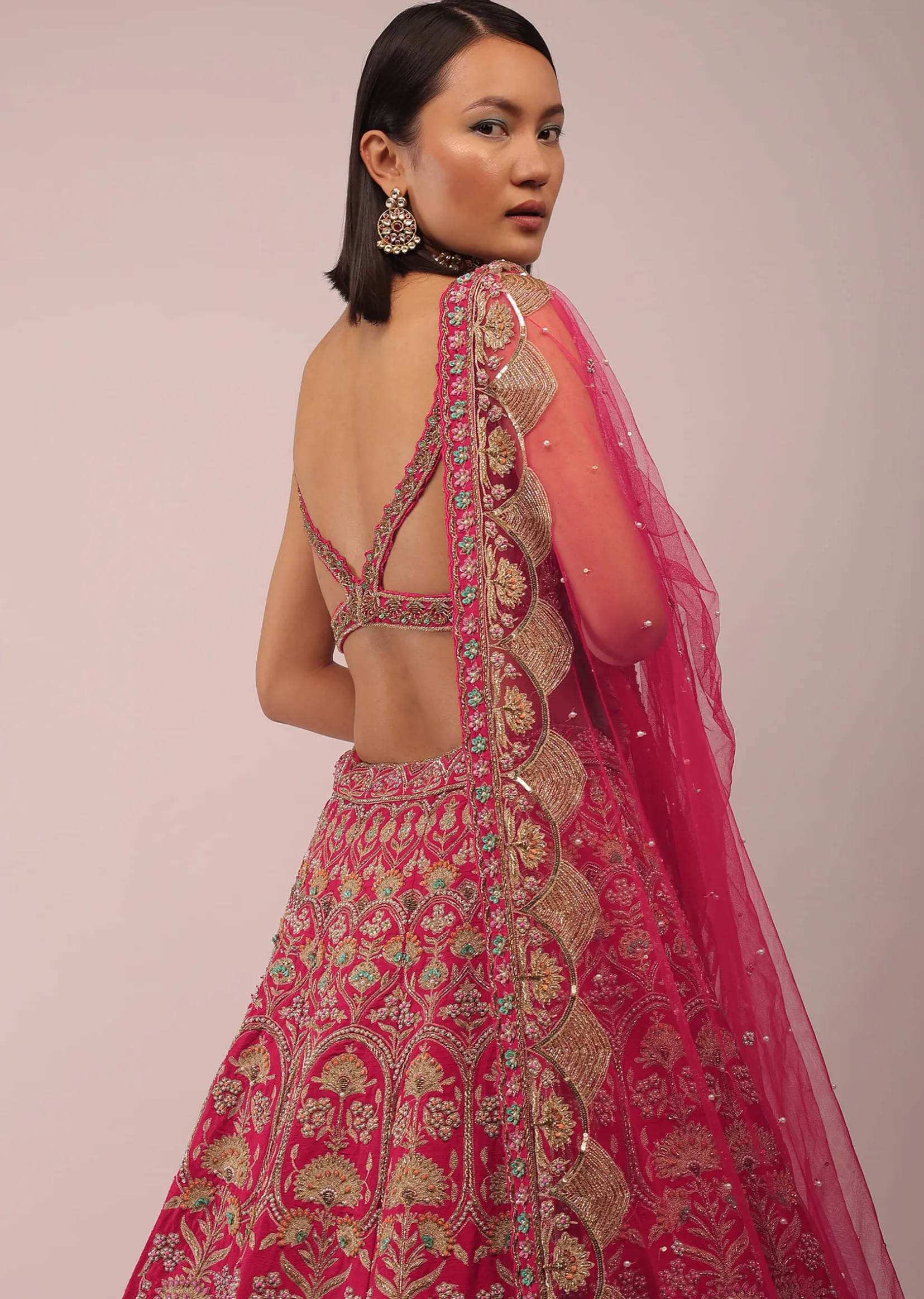 Rani Pink Lehenga In Golden Zari Work Embroidery Inspired By Mughal Architecture With Matching Net Dupatta In Embroidered Buttis