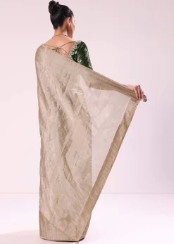 Silver Zari Tissue Saree With Embroidered Emerald Green Stitched Blouse