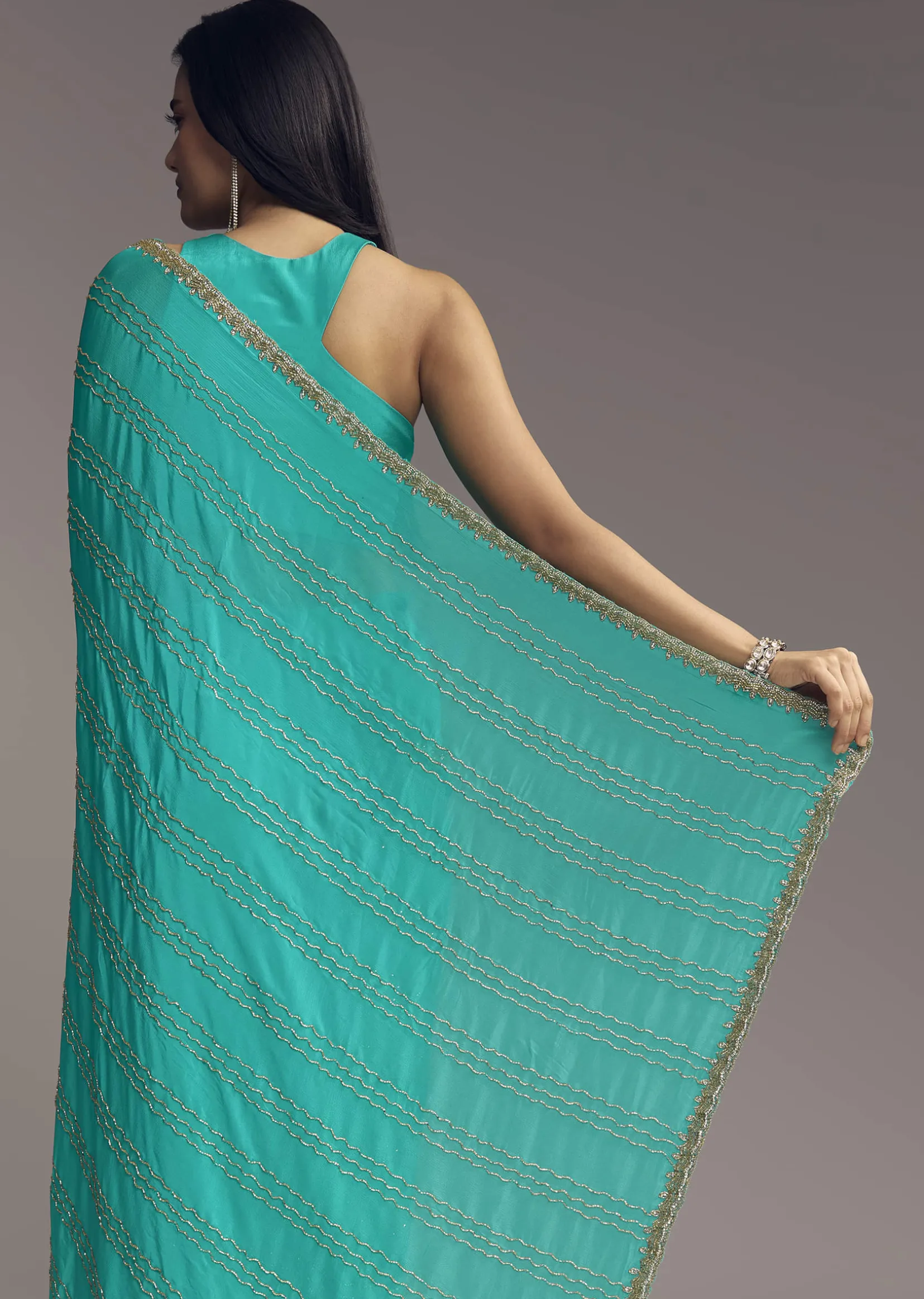 Turquoise Blue Embroidered Chinon Saree With Wavy Border