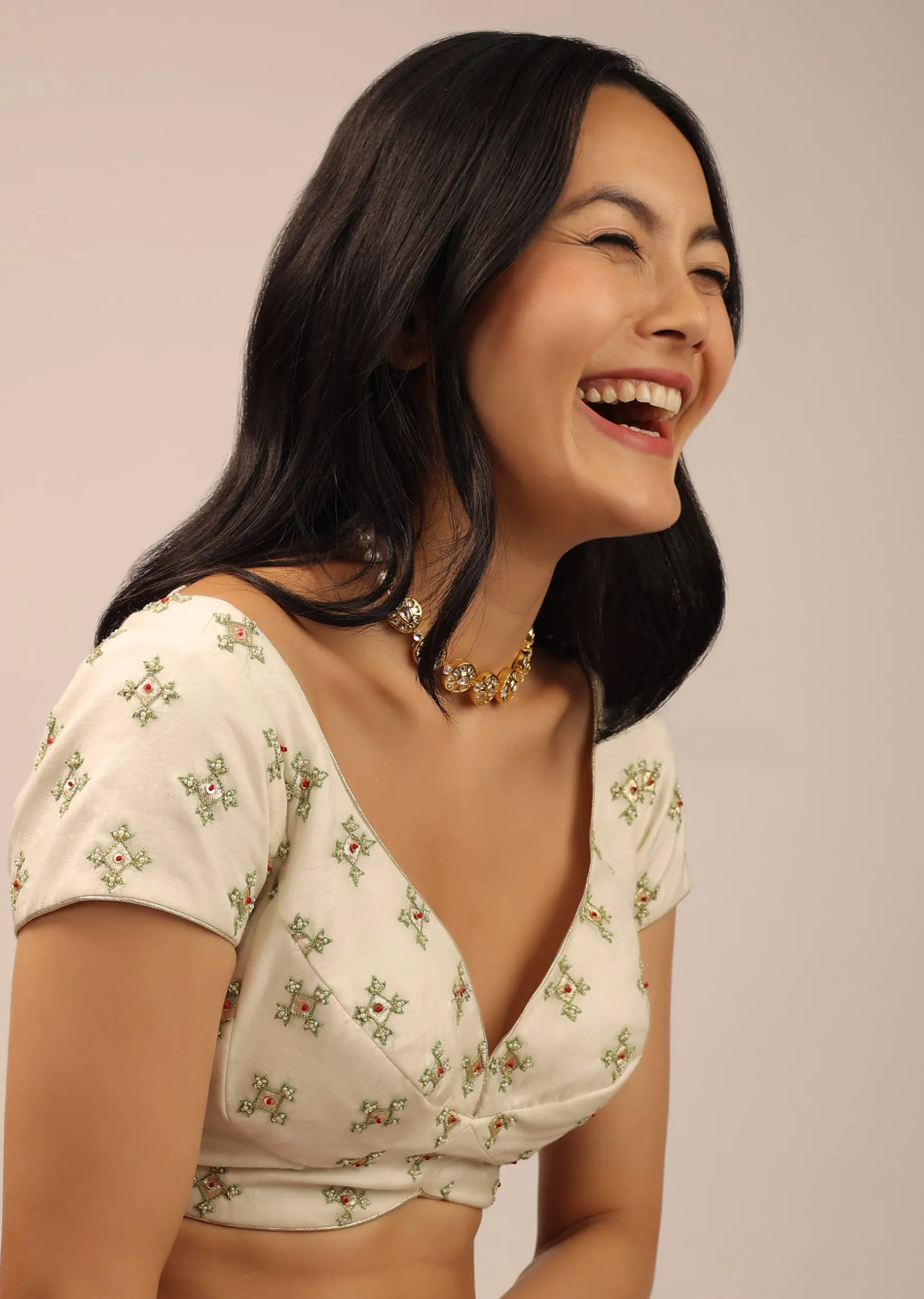 White Padded Blouse With Golden zardosi Border And Thread Work In Green