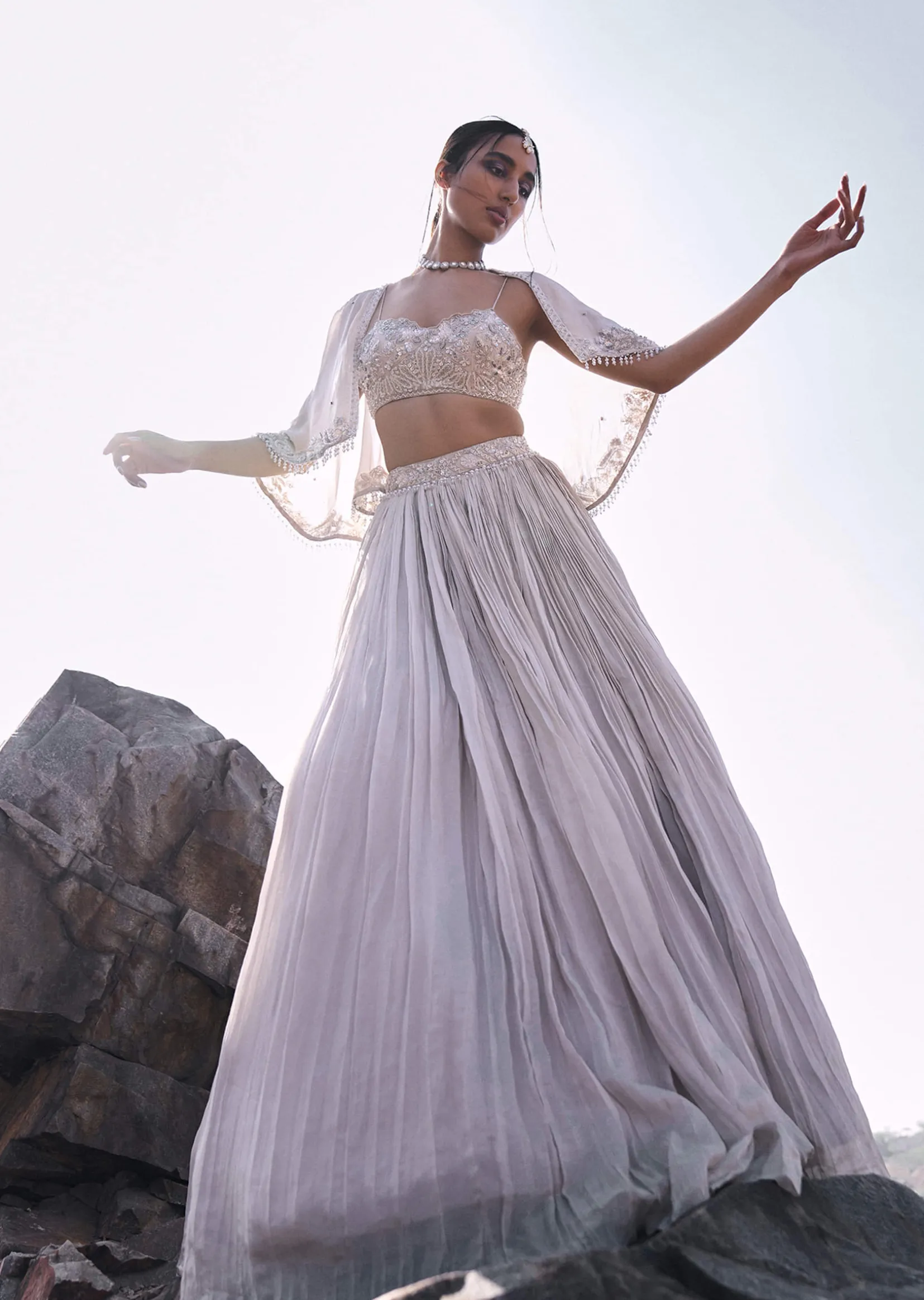 White Ruched Lehenga With Spaghetti Blouse And Cape