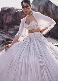 White Ruched Lehenga With Spaghetti Blouse And Cape